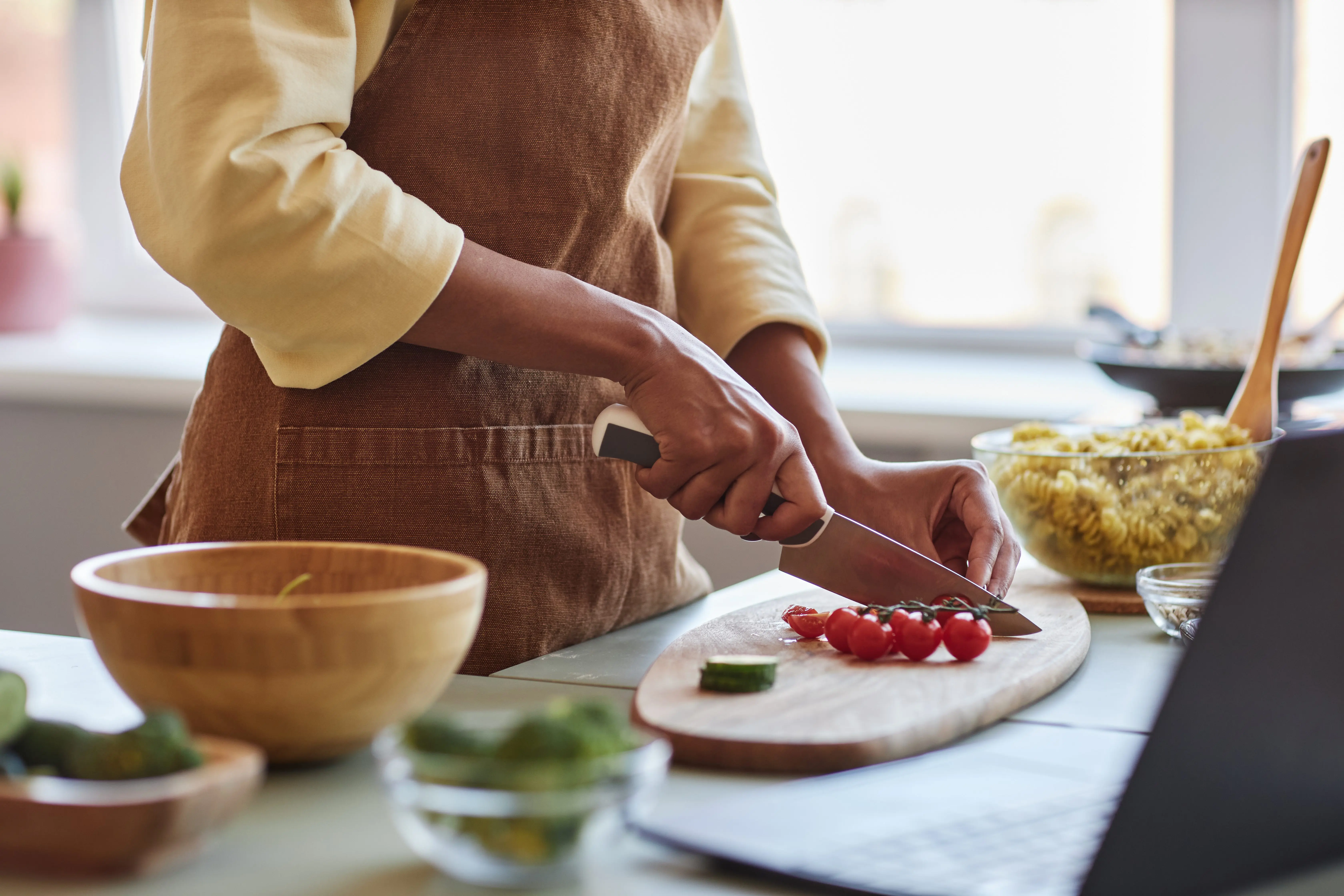 young-black-woman-cutting-vegetables-cooking-with-organic-food-in-kitchen