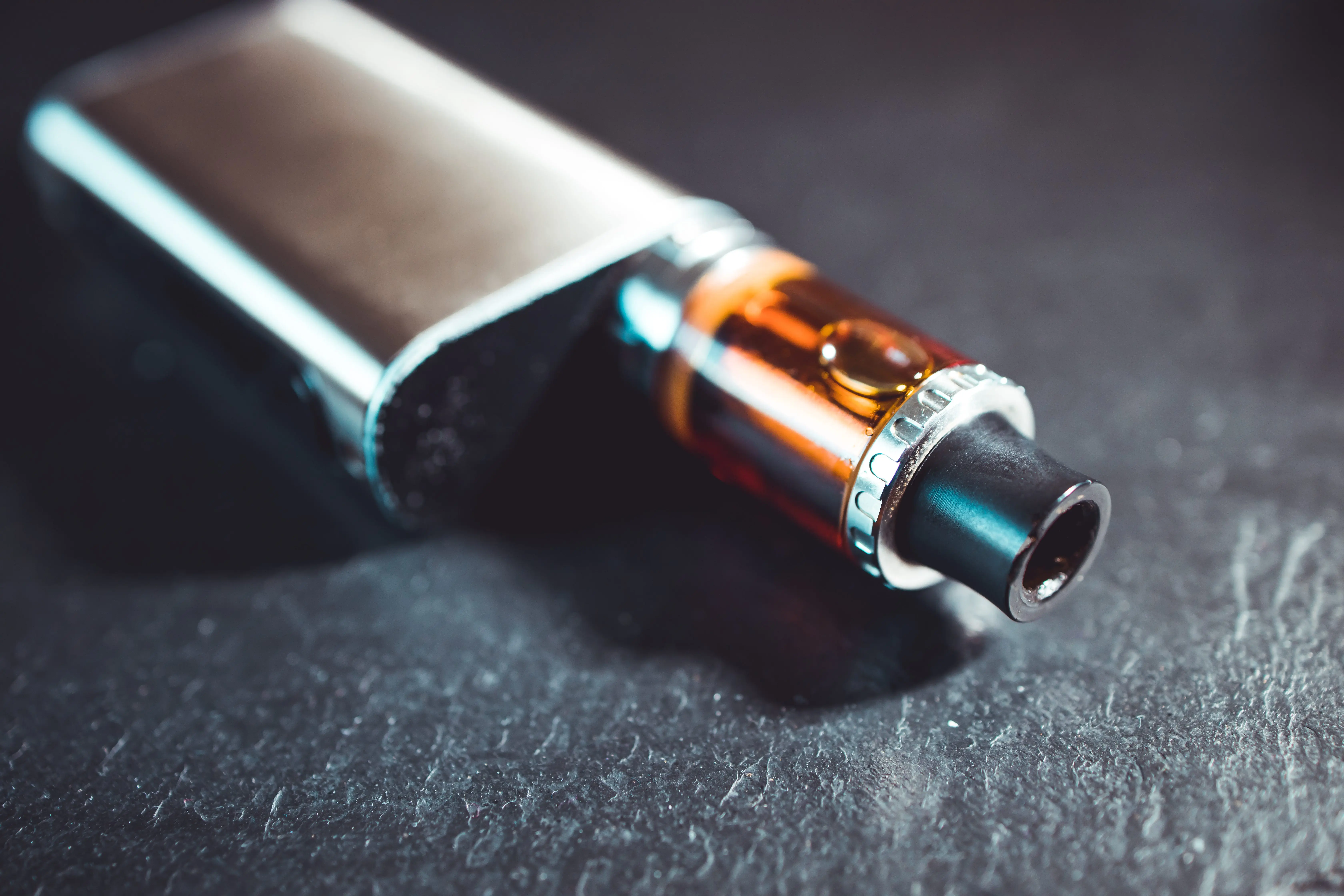 vape-pen-metal-electronic-cigarette-with-vaping-dark-background