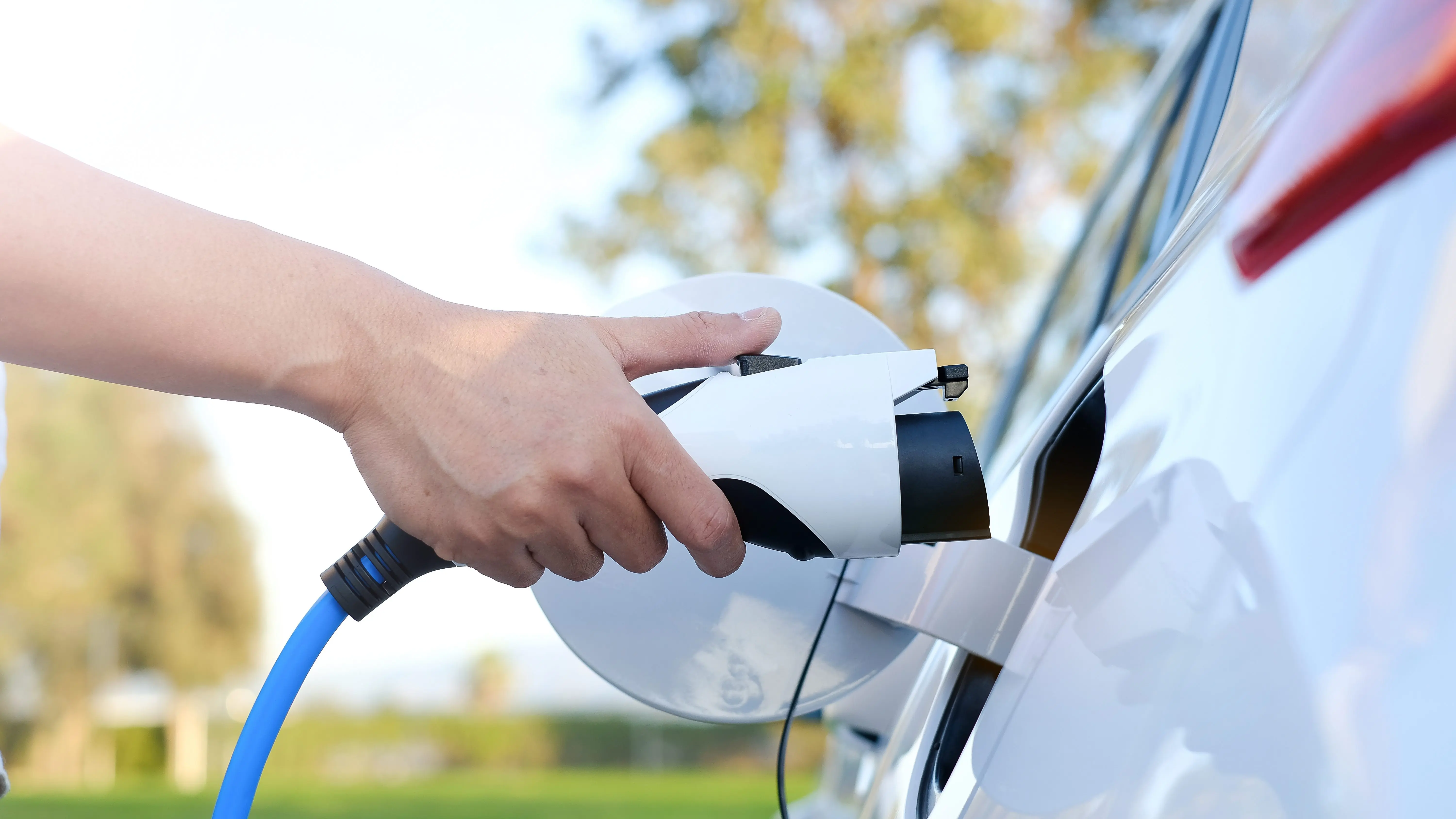 electric-car-or-ev-is-charging-at-station-man-use-the-white-po