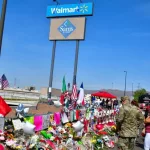 Flowers^ posters^ toys and other memorabilia left for the victims of the Walmart shooting on 3 August 2019. El Paso^ Texas / USA - August 2019
