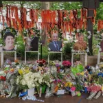 Highland Park^ IL July 16^ 2022^ memorial to the High Park parade shooting victims with their photos and flower bouquets^ mass shooting