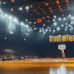 Blurred background of intimate atmosphere of a basketball arena during a crucial playoff game^ filled with excitement^ energy^ and passionate fans enjoying every moment.