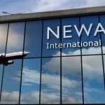 Aircraft landing at Newark^ New Jersey^ USA 3D rendering illustration. Arrival in the city with the glass airport terminal and reflection of jet plane. Travel^ business^ tourism and transport.