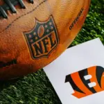 Cincinnati Bengals NFL team Logo and American football ball on Green Grass. CINCINNATI^ USA^ FEBRUARY 10^ 2025