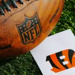 Cincinnati Bengals NFL team Logo and American football ball on Green Grass. CINCINNATI^ USA^ FEBRUARY 10^ 2025