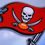 LOGO OF Tampa Bay Buccaneers. American football match^ silhouette of players.