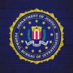 The FBI flag (Federal Bureau of Investigation) painted on a brick wall.