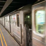 Fast moving train in New York subway. 18th street station.