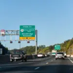 Highway i-95 interstate road in Virginia with cars on commute in morning traffic near Washington DC and sign for Prince William Parkway and ManassasWoodbridge^ USA - October 18^ 2021: