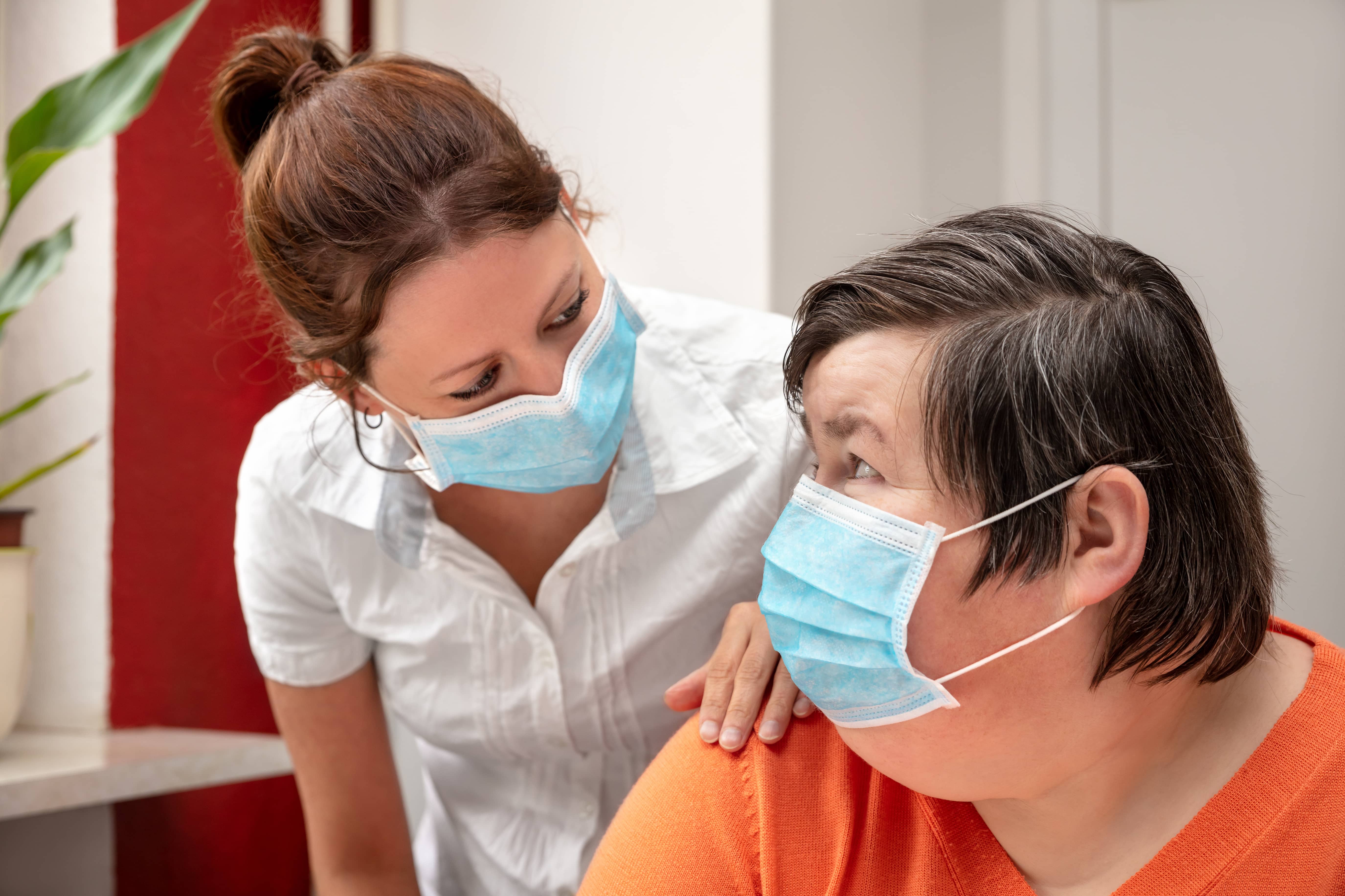 mentally-disabled-woman-and-nurse-or-caretaker-wearing-a-surgica