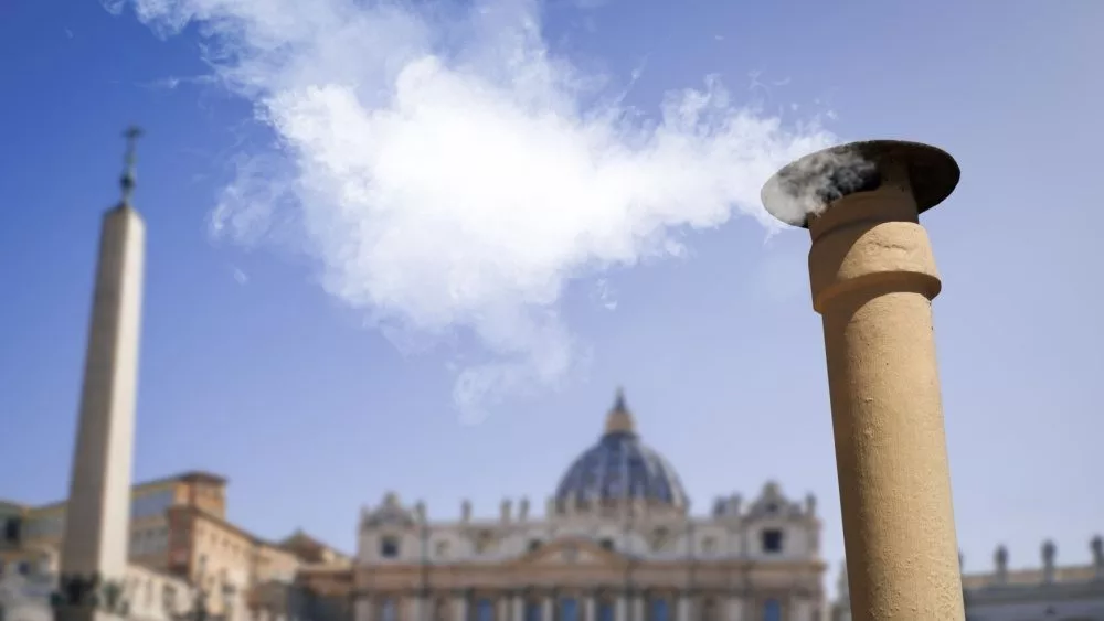 Vatican City - 04-25-2025: White smoke from the chimney on top of the Sistine Chapel. It indicates that the Pope has been elected.