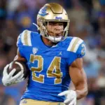UCLA running back Zach Charbonnet (24) escapes a tackle-attempt by Washington linebacker Alphonzo Tuputala (11) during an NCAA college football game Friday^ Sept. 30^ 2022^ in Pasadena^ Calif.