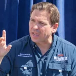 Florida Republican Governor and presidential candidate Ron DeSantis greets supporters at the Iowa State Fair fair side chats in Des Moines^ Iowan August 12^ 2023