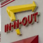 In-N-Out Burger sign is seen at the entrance to its restaurant in Grants Pass^ Oregon. In-N-Out Burger is an American fast food chain based in Irvine^ California.