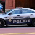 Prince George's County^ Maryland police car sits parked on a street in National Harbor in front of a public parking garage.