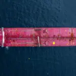 Aerial view crude oil tanker ship at sea^ Red crude oil tanker ship top view^ Logistic and maritime transpoprtation of petroleum^ Modern offshore terminal loading tanker ship.