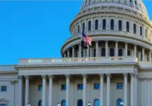 Close-up of the United States flag in front of the Capitol Building's dome in the morning^ Washington^ D.C.