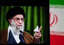 This image captures Iranian Supreme Leader Ali Khamenei giving a speech^ with the Iranian flag prominently displayed.