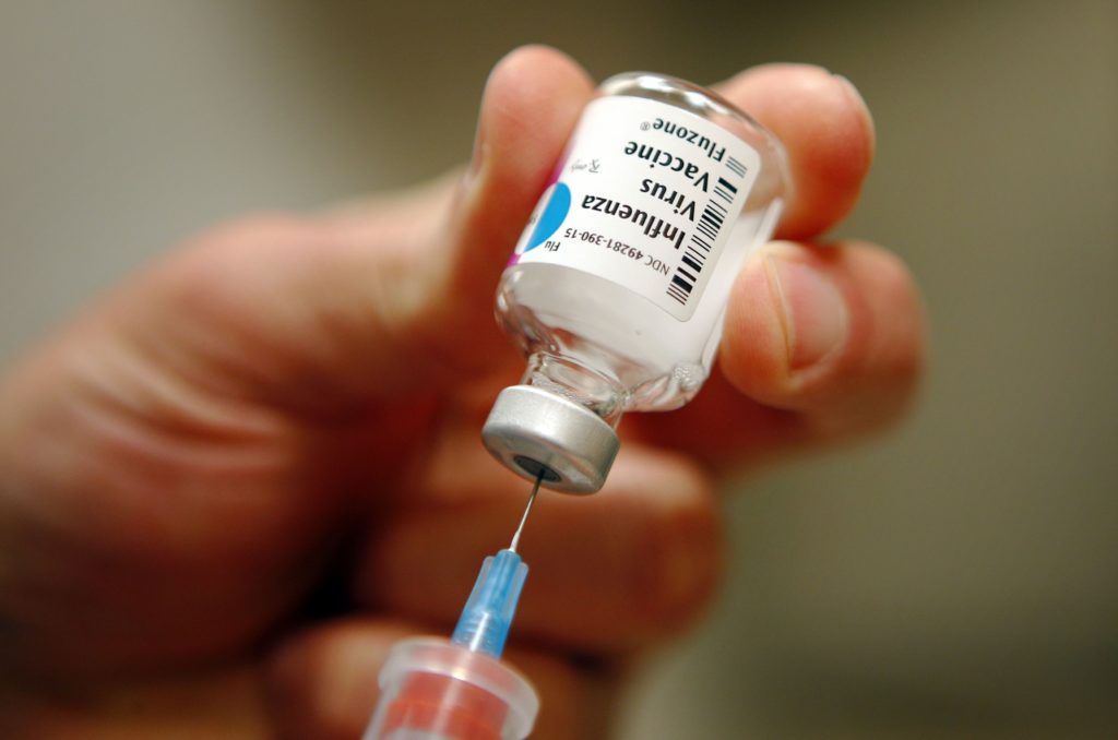 file-photo-of-a-nurse-preparing-an-injection-of-the-influenza-vaccine-at-massachusetts-general-hospital-in-boston