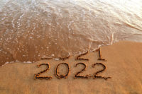 new-year-2022-and-old-year-2021-on-sandy-beach-with-waves