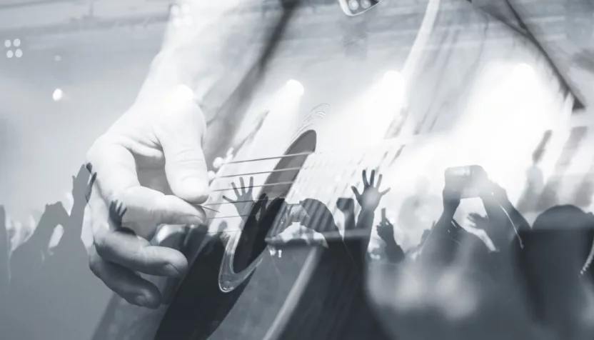 Guitarist with the audience in a double exposure.