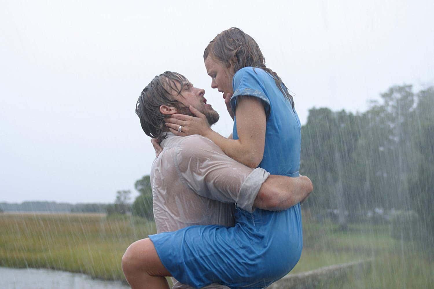 Ryan Gosling and Rachel McAdams in The Notebook hold each other passionately in the rain