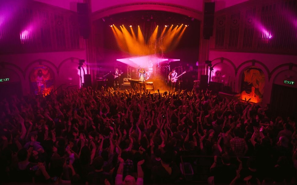 Walk the Moon performing at The Neptune with fuchsia lighting
