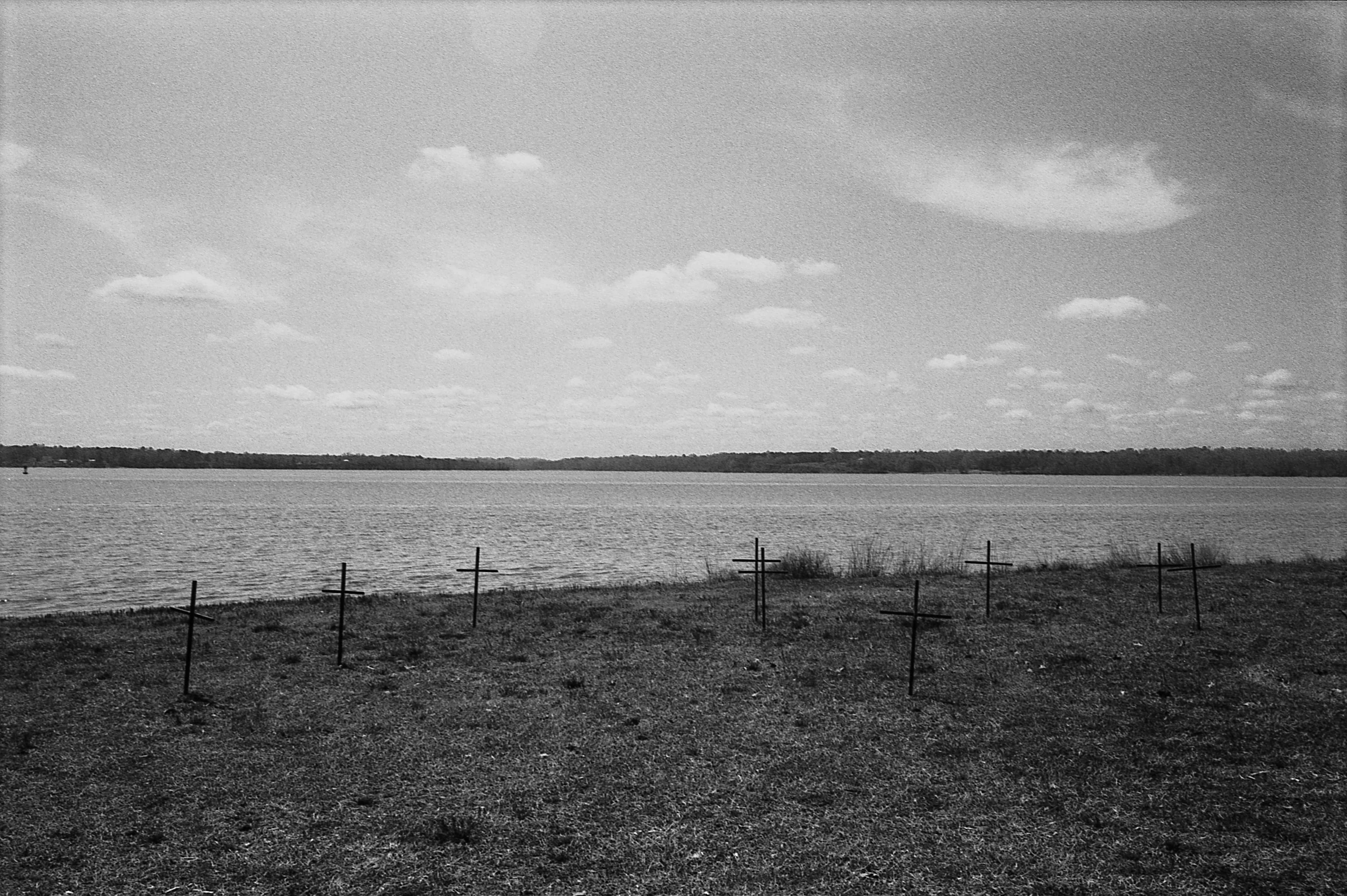 A cemetery on a beach, black and white photo.