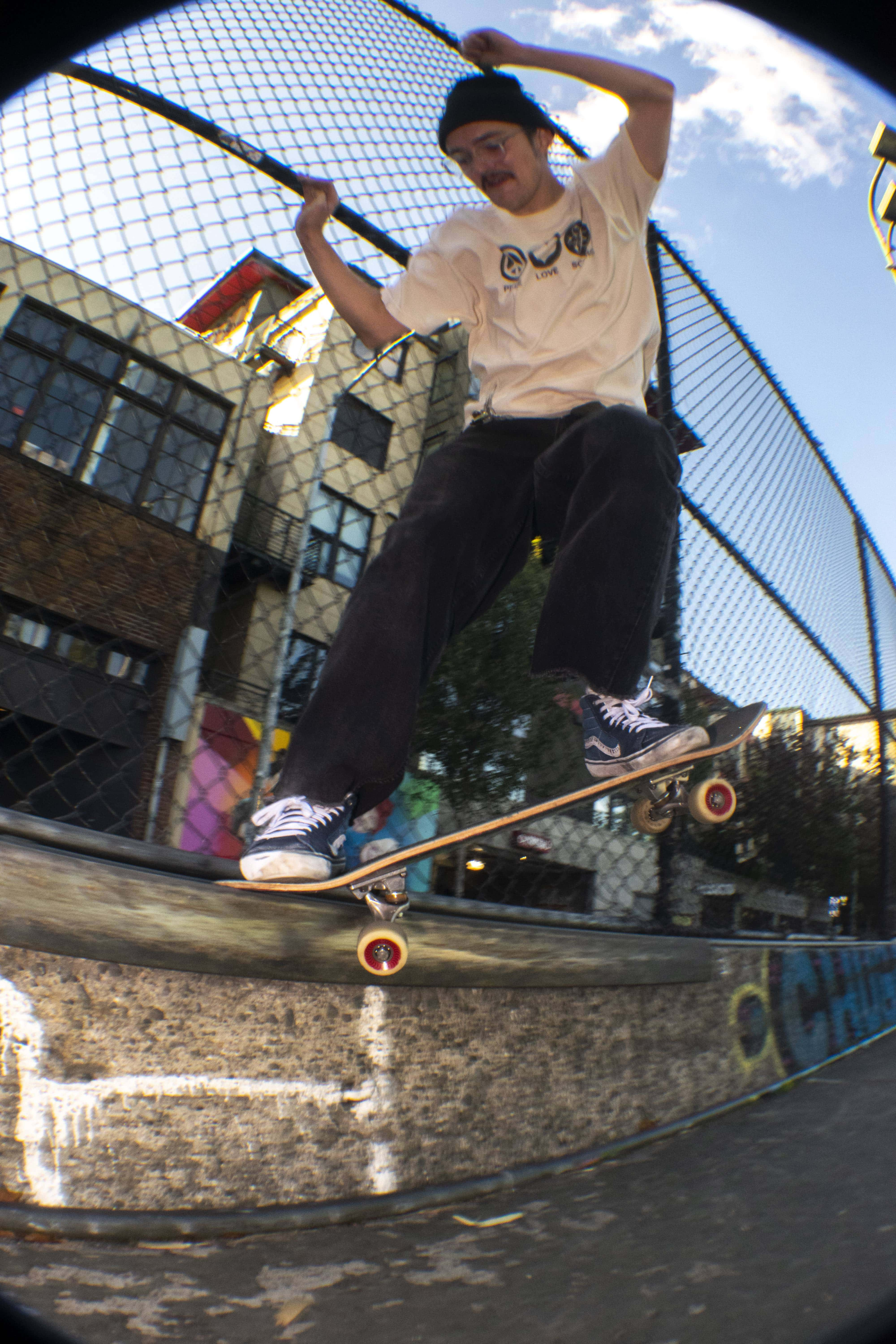 Image of a skateboard grinding against a curb.