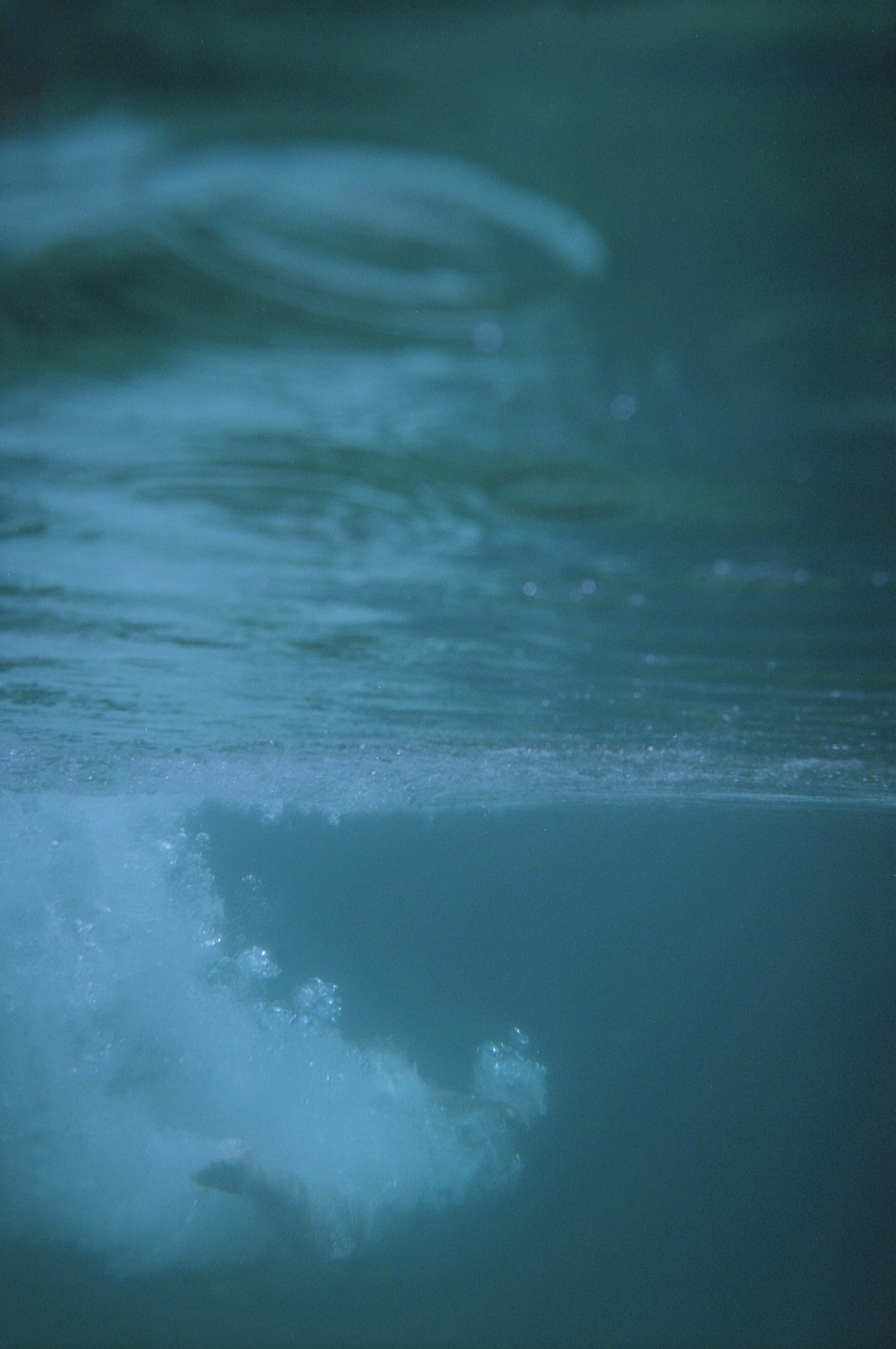 Underwater photo of someone after jumping into the water.