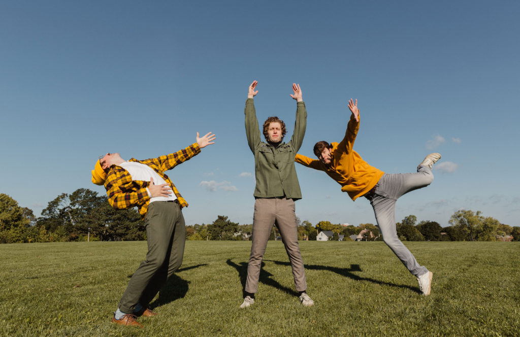Diet lite members are standing in fun poses in the grass