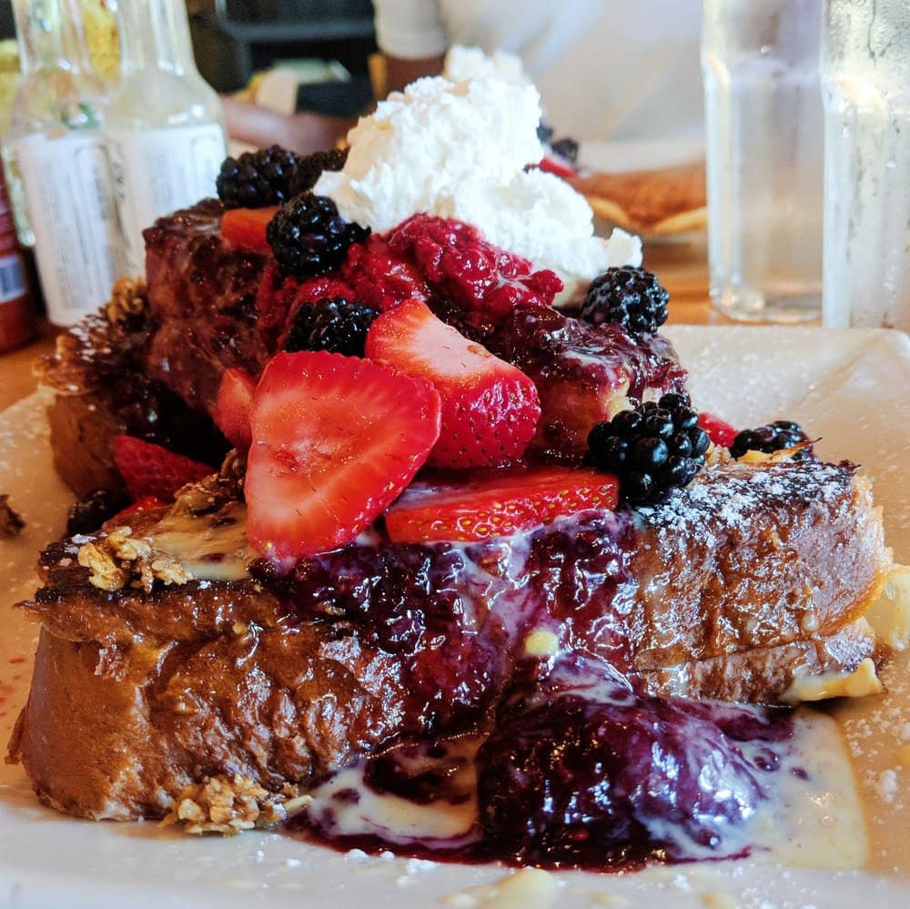 Oatmeal cobbler french toast with berries and whipped cream on top