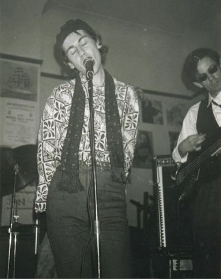 This photograph shows Television Personalities members Dan Treacy (singing) and Jowe Head (playing bass) at The Living Room on February 10th, 1984.