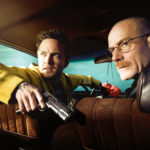 Walter White and Jesse Pinkman sitting in a car with a gun