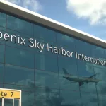 Airliner landing reflecting in the windows with phoenix sky harbor international airport text 3D rendering