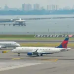 : Delta Airlines and American Eagle planes seen at the runway of LaGuardia International Airport. Manhattan^ New York^ USA - August 5^ 2025