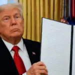 President Donald Trump signs executive orders in the Oval Office of the White House on January 20^ 2025 in Washington^ DC. Trump takes office for his second term