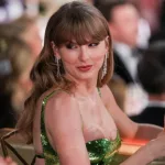 getty_taylorswiftraisesglass_040224153030