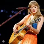 getty_taylorswiftplaysguitarlookingdown_011625978062