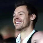 getty_harrystylessmilinginstands_030325807777