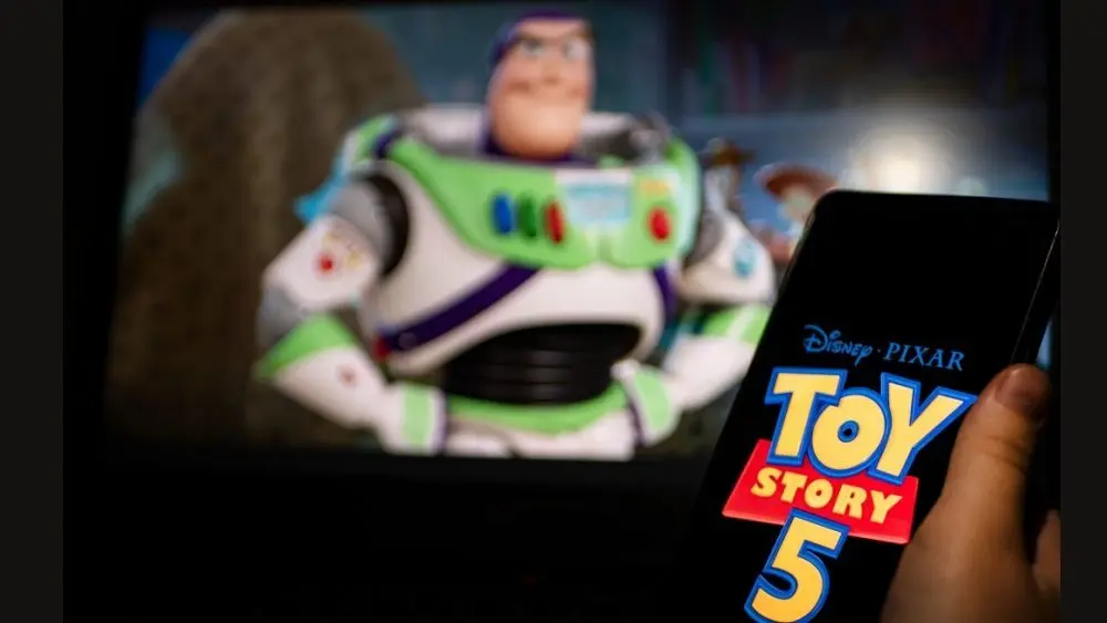 New Disney film Toy Story 5. A man's hand holds a phone with a poster of the new cartoon Toy Story 5 by Pixar. Moscow November 2025.
