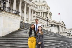 Three students standing on Capitol steps