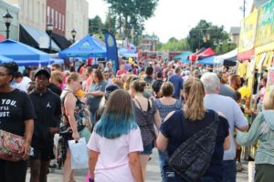 crowd of people on street in downtown Lenoir