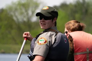 Amanda Lasley in uniform, paddling in kayak