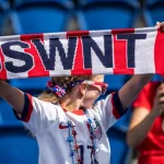 A fan holds USWNT scarf before the 2019 FIFA Women's World Cup match between USA and Chile.