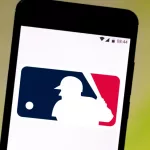 Major League Baseball Logo (MLG) is displayed on a smartphone with a green background