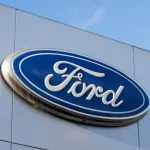 Closeup of the Ford logo seen at a Ford dealership store in Sunnyvale^ California. Ford Motor Company is an American multinational automobile manufacturer. Sunnyvale^ CA^ USA - Nov 22^ 2023