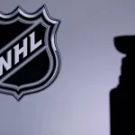 National Hockey LeagueLogo of NHL club on the screen. Stenley Cup Trophy Silhouette.