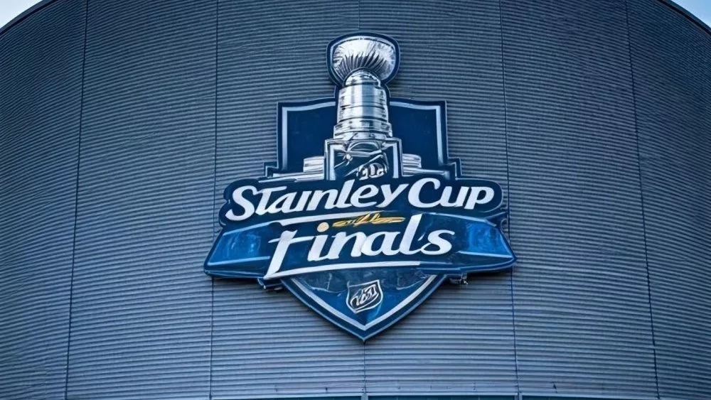 the front facade of a hockey arena with the NHL Stanley Cup Finals logo on the front of the building.