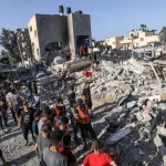 Palestinians evacuate wounded after an Israeli airstrike in Rafah refugee camp^ southern Gaza Strip^ on October 13 2023.